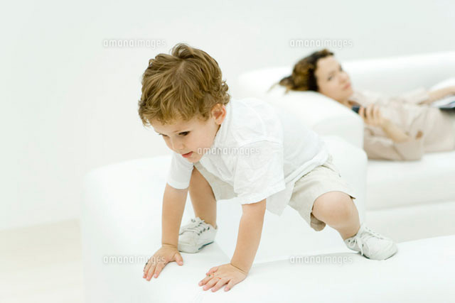 Little boy perched precariously on top of armchair
(c)Alix Minde/PhotoAlto