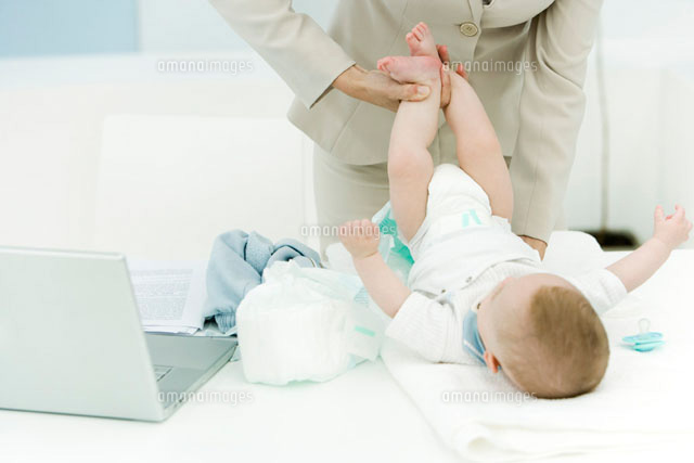 Professional woman changing baby’s diaper on desk
(c)Alix Minde/PhotoAlto