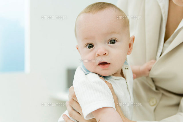 Infant sitting on mother’s lap, looking at camera
(c)Alix Minde/PhotoAlto