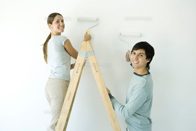 Couple painting wall with rollers over their shoulder
(c)Alix Minde/PhotoAlto
