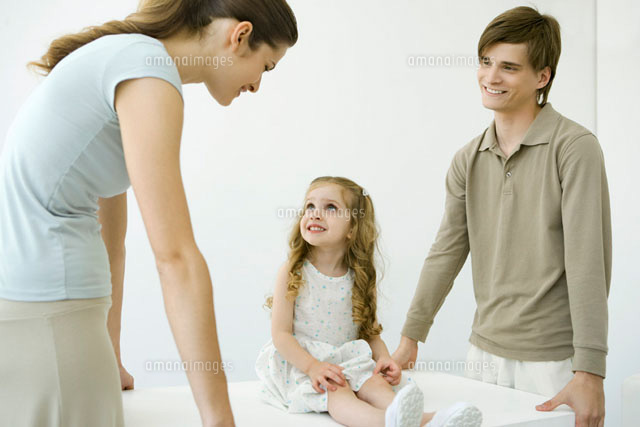 Young parents holding table, daughter sitting on table
(c)Alix Minde/PhotoAlto