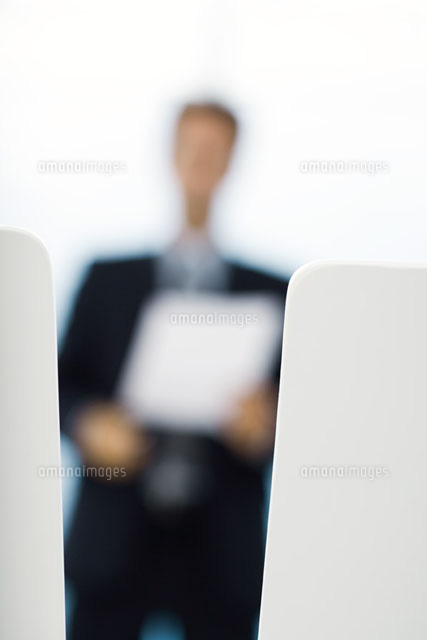 Blurred silhouette of businessman holding document
(c)Frederic Cirou/PhotoAlto