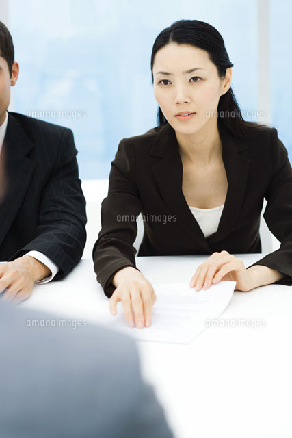 Business associates in meeting,woman holding out document
(c)Frederic Cirou/PhotoAlto