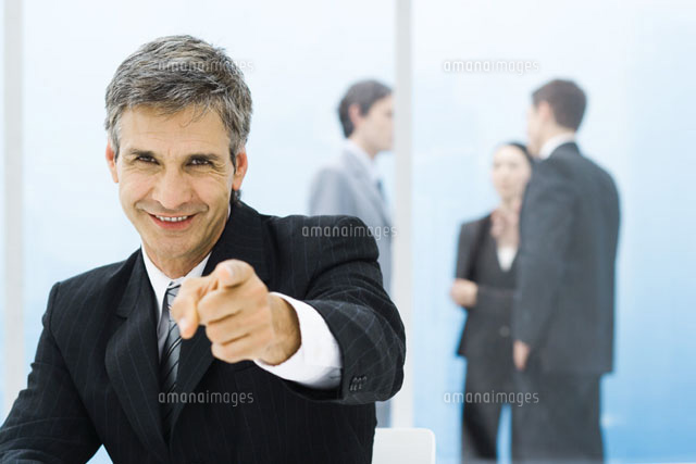 Graying businessman smiling and pointing at camera
(c)Frederic Cirou/PhotoAlto