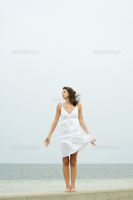 Girl in sundress standing at the beach,tousled by wind
(c)Odilon Dimier/PhotoAlto