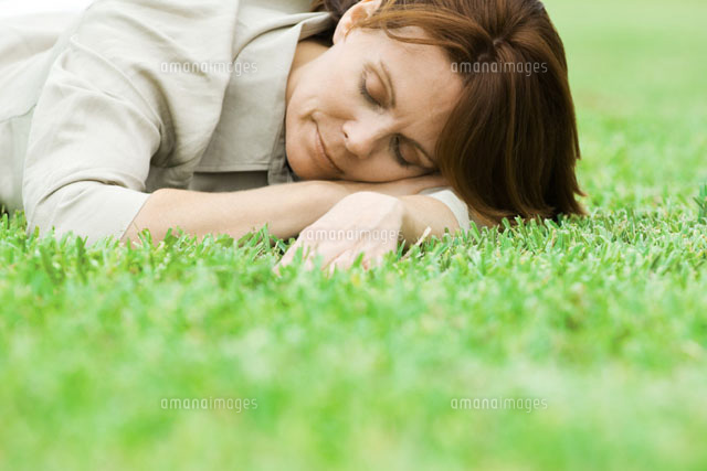 Woman lying on grass with head resting on arms,eyes closed
(c)Odilon Dimier/PhotoAlto