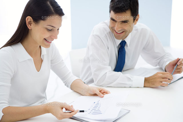 Two business associates studying graph together,smiling
(c)Sigrid Olsson/PhotoAlto