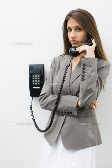 Teen girl using landline phone,looking at camera
(c)Frederic Cirou/PhotoAlto