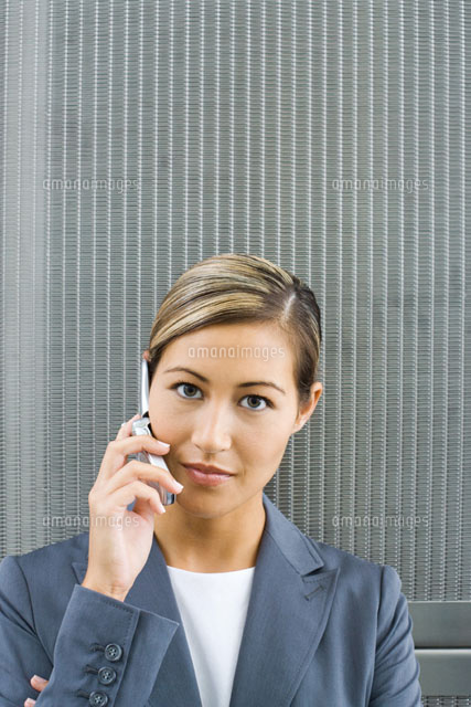 Woman using cell phone,looking at camera,portrait
(c)Frederic Cirou/PhotoAlto