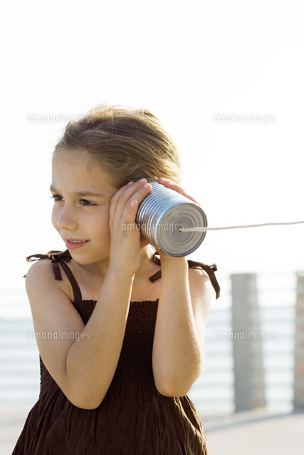 Little girl listening to tin can phone
(c)Frederic Cirou/PhotoAlto
