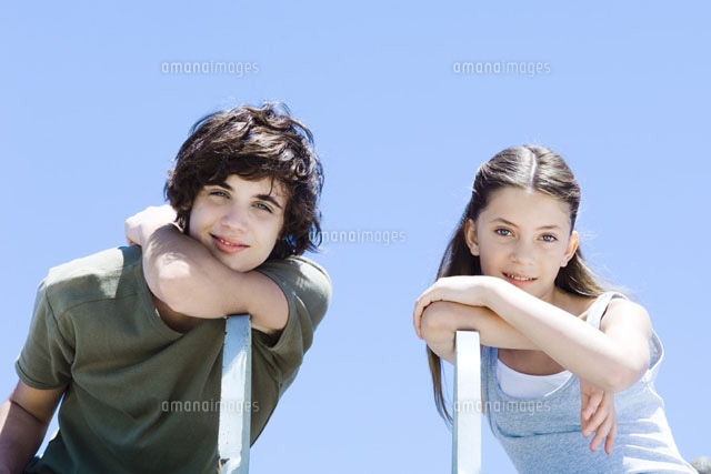 Brother and sister sitting sideways in chairs
(c)Michele Constantini/PhotoAlto