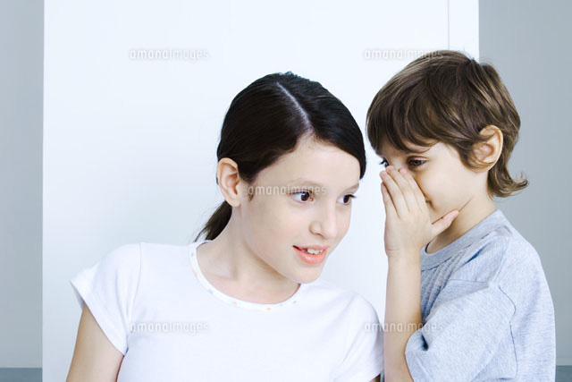 Brother whispering to his sister,hand covering mouth
(c)Michele Constantini/PhotoAlto