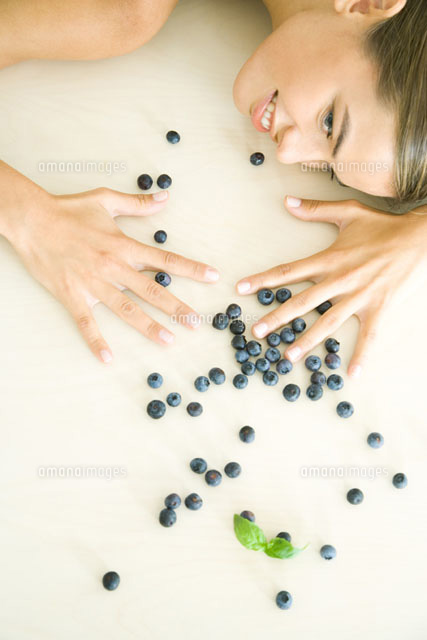 Blueberries scattered,woman spreading hands over them
(c)Rafal Strzechowski/PhotoAlto