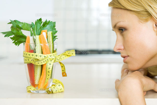 Woman looking at vegetables with a measuring tape bow
(c)Rafal Strzechowski/PhotoAlto