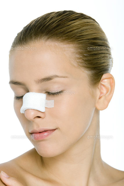 Young woman with bandaged nose,eyes closed
(c)Alix Minde/PhotoAlto