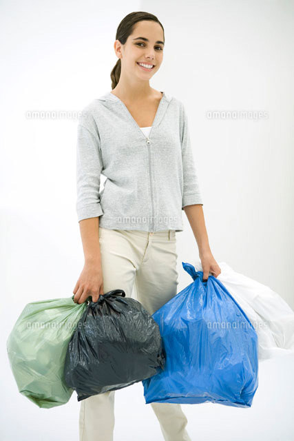 Teen girl carrying several garbage bags,smiling at camera
(c)Sigrid Olsson/PhotoAlto