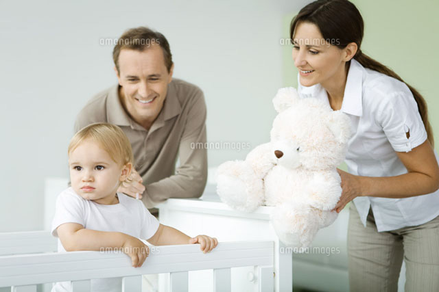 Parents standing beside toddler in crib
(c)Ale Ventura/PhotoAlto