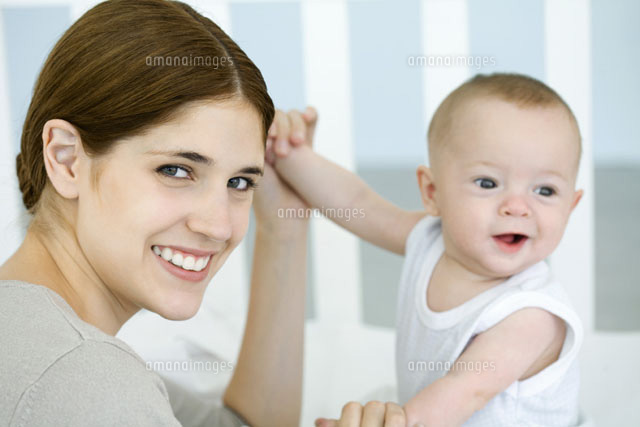 Mother holding baby’s hands and smiling at camera
(c)Ale Ventura/PhotoAlto