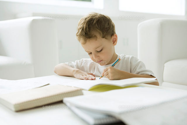 Little boy sitting at coffee table,working on homework
(c)Sigrid Olsson/PhotoAlto