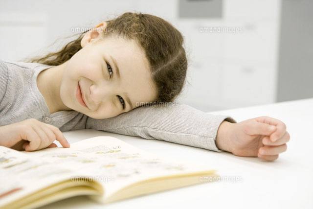 Girl sitting at table with book,resting head on arm
(c)Sigrid Olsson/PhotoAlto