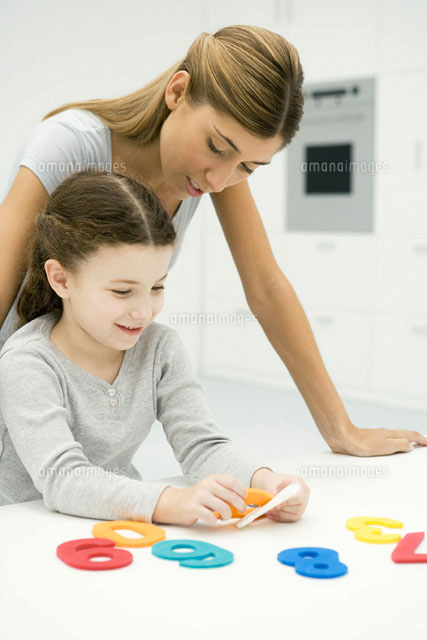Mother and daughter looking at cut out numbers together
(c)Sigrid Olsson/PhotoAlto