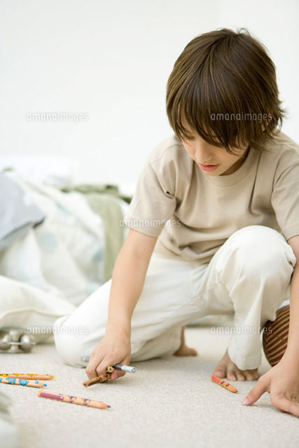 Boy crouching on floor,picking up colored pencils
(c)Sigrid Olsson/PhotoAlto