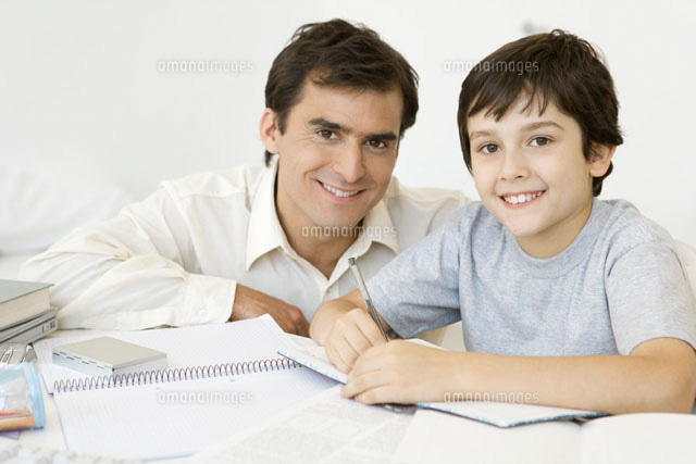 Boy doing homework with father,both smiling at camera
(c)Sigrid Olsson/PhotoAlto