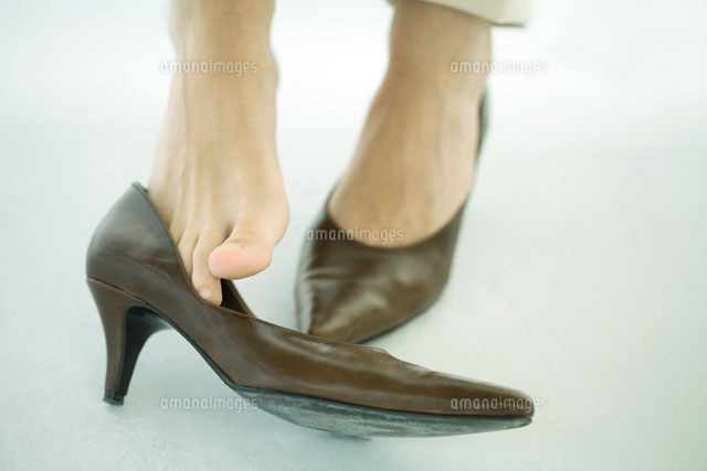 Woman wearing high heels,one shoe off
(c)Ale Ventura/PhotoAlto