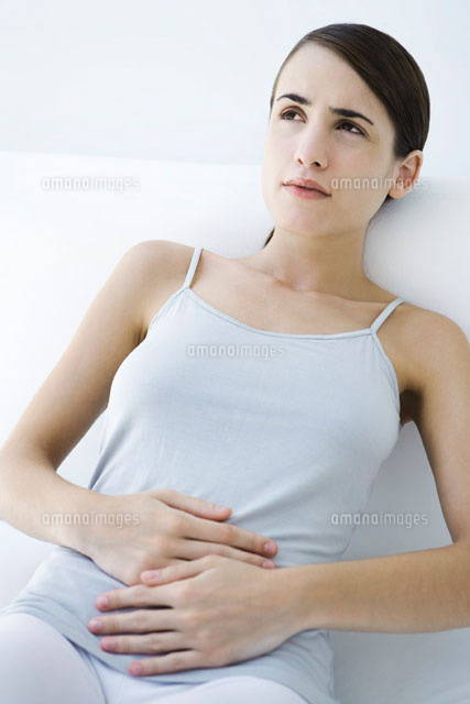 Woman reclining,holding stomach
(c)Alix Minde/PhotoAlto