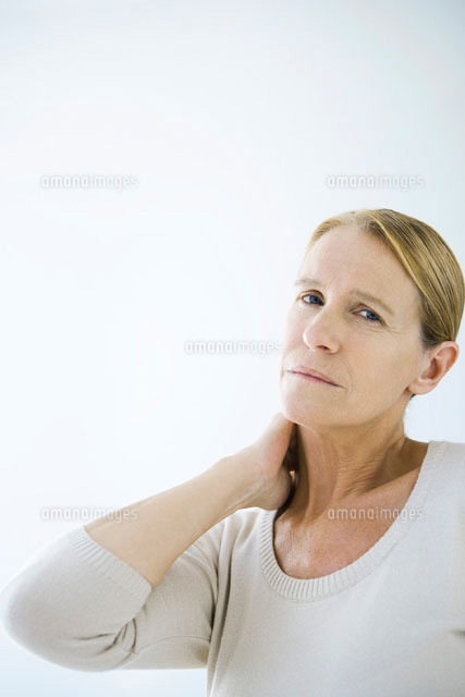Mature woman rubbing her neck,looking at camera
(c)Alix Minde/PhotoAlto
