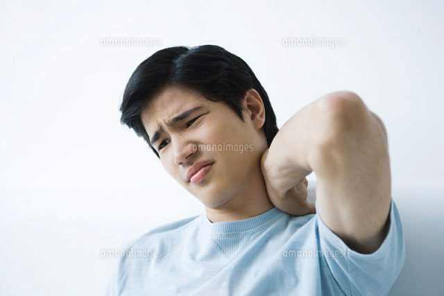 Young man holding neck,furrowing brow
(c)Alix Minde/PhotoAlto