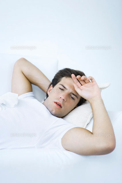 Man lying on sofa with tissue on his chest
(c)Alix Minde/PhotoAlto
