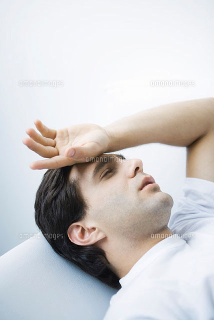 Man reclining with eyes closed,hand on forehead
(c)Alix Minde/PhotoAlto