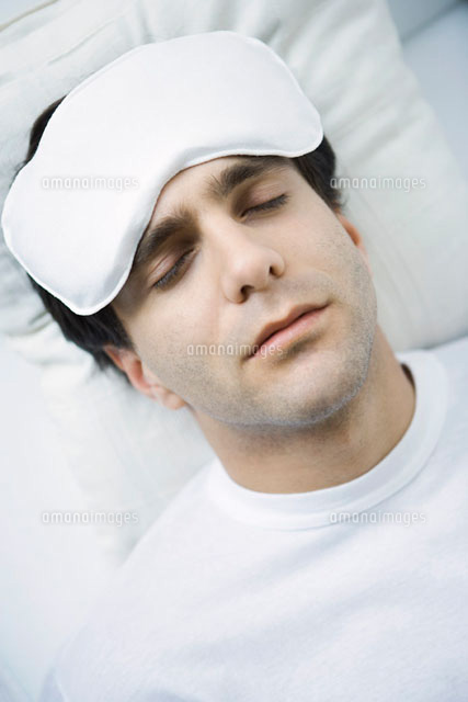 Man reclining with ice pack on his forehead,eyes closed
(c)Alix Minde/PhotoAlto