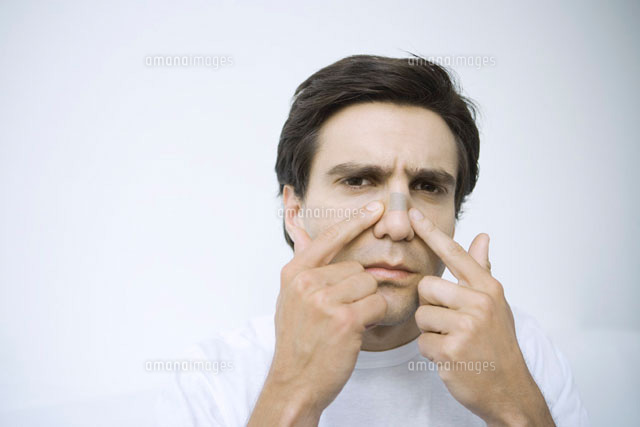 Man applying adhesive bandage on his nose
(c)Alix Minde/PhotoAlto
