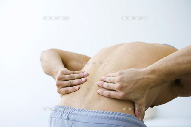 Man bending over,holding lower back,cropped view
(c)Alix Minde/PhotoAlto