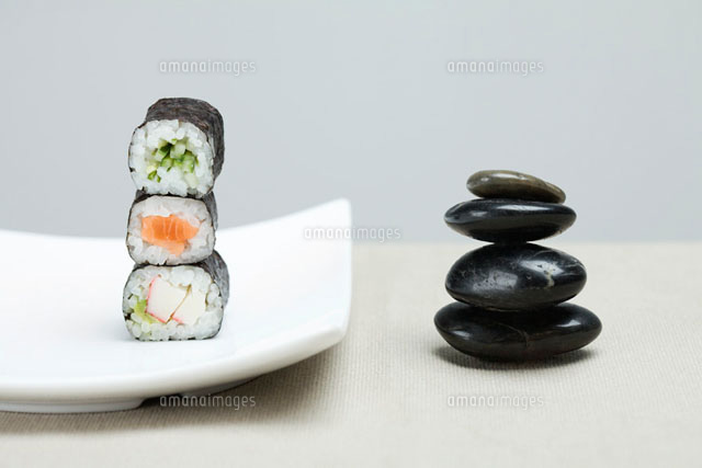 Three pieces of sushi placed alongside shiny black pebbles
(c)Ale Ventura/PhotoAlto