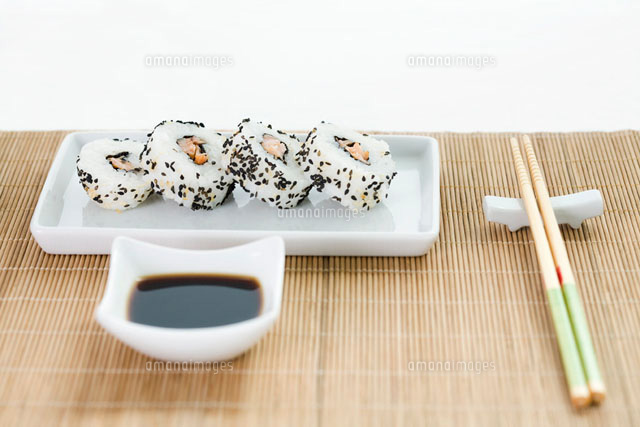 Sushi with soy sauce and chopsticks arranged on placemat
(c)Ale Ventura/PhotoAlto