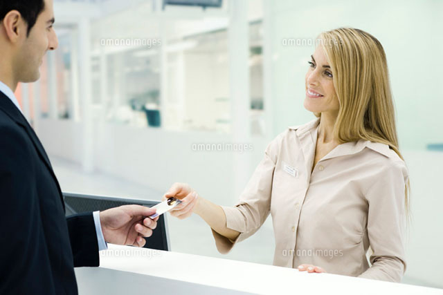 Customer handing card to customer service representative
(c)Eric Audras/PhotoAlto