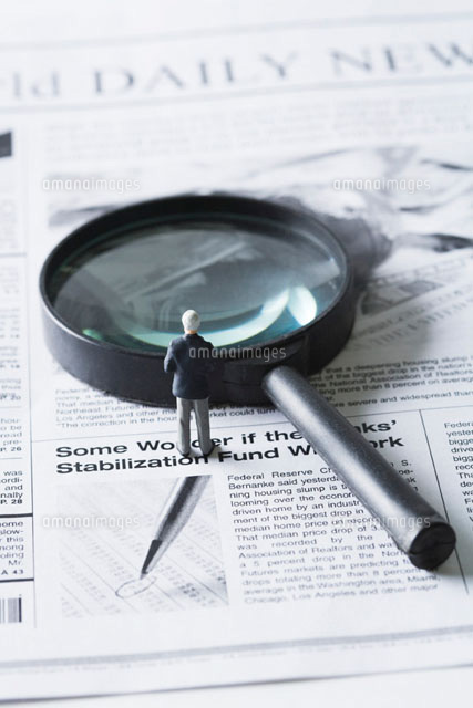 Miniature businessman standing before magnifying glass
(c)Laurence Mouton/PhotoAlto