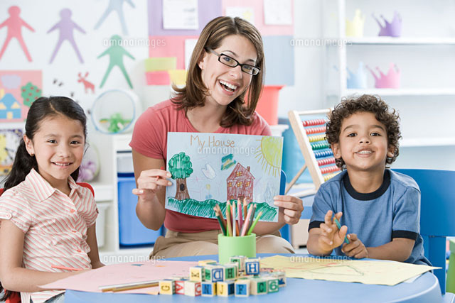 A portrait of a teacher and children
(c)Image Source