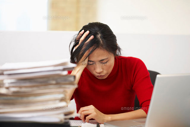 Frustrated Businesswoman Sitting at Desk
(c)Radius Images