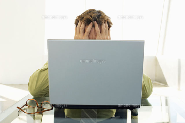 Stressed businessman using laptop in office
(c)moodboard