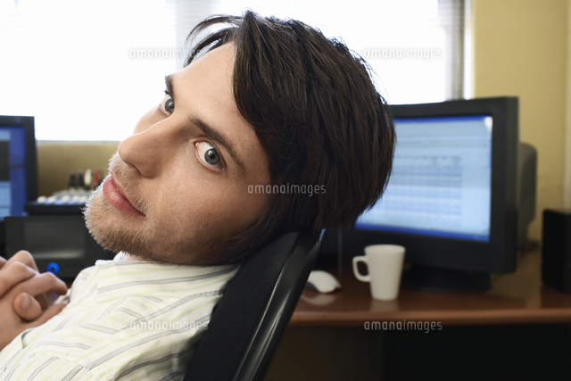 man sitting at desk with computers 11044019423 写真素材