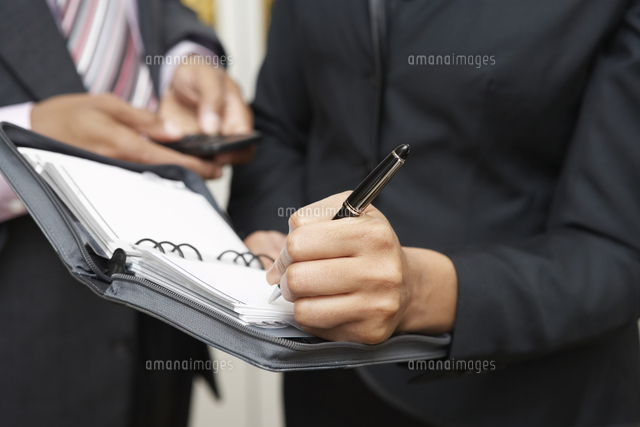 Business woman writing in diary mid section
(c)moodboard