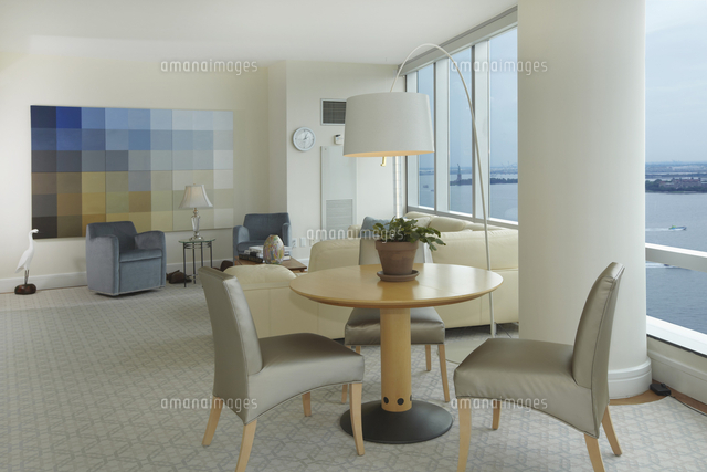 modern dining and living rooms with large windows and ocean view