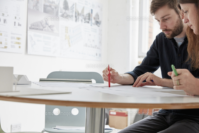 a modern office two people at a meeting discussing plans