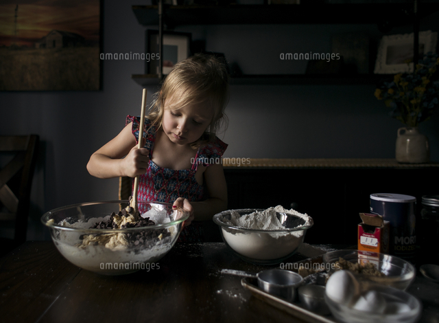 Girl mixing batter in bowl on table at home
(c)Cavan Images
