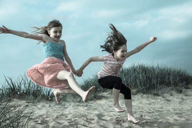 Full Length Of Young Girls Jumping In Mid-air
(c)Marcin Bulinski / EyeEm